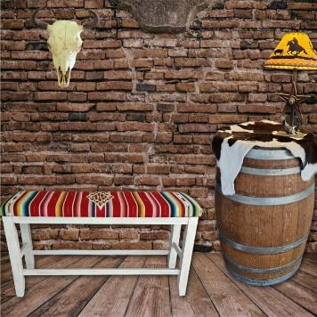 Western Home Décor Setup with Red Serape Bench and Whiskey Barrel Table Against Brick Wall