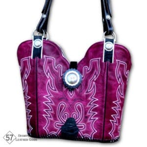 Fuschia pink cowboy boot purse with silver conchos, black horse tack handles