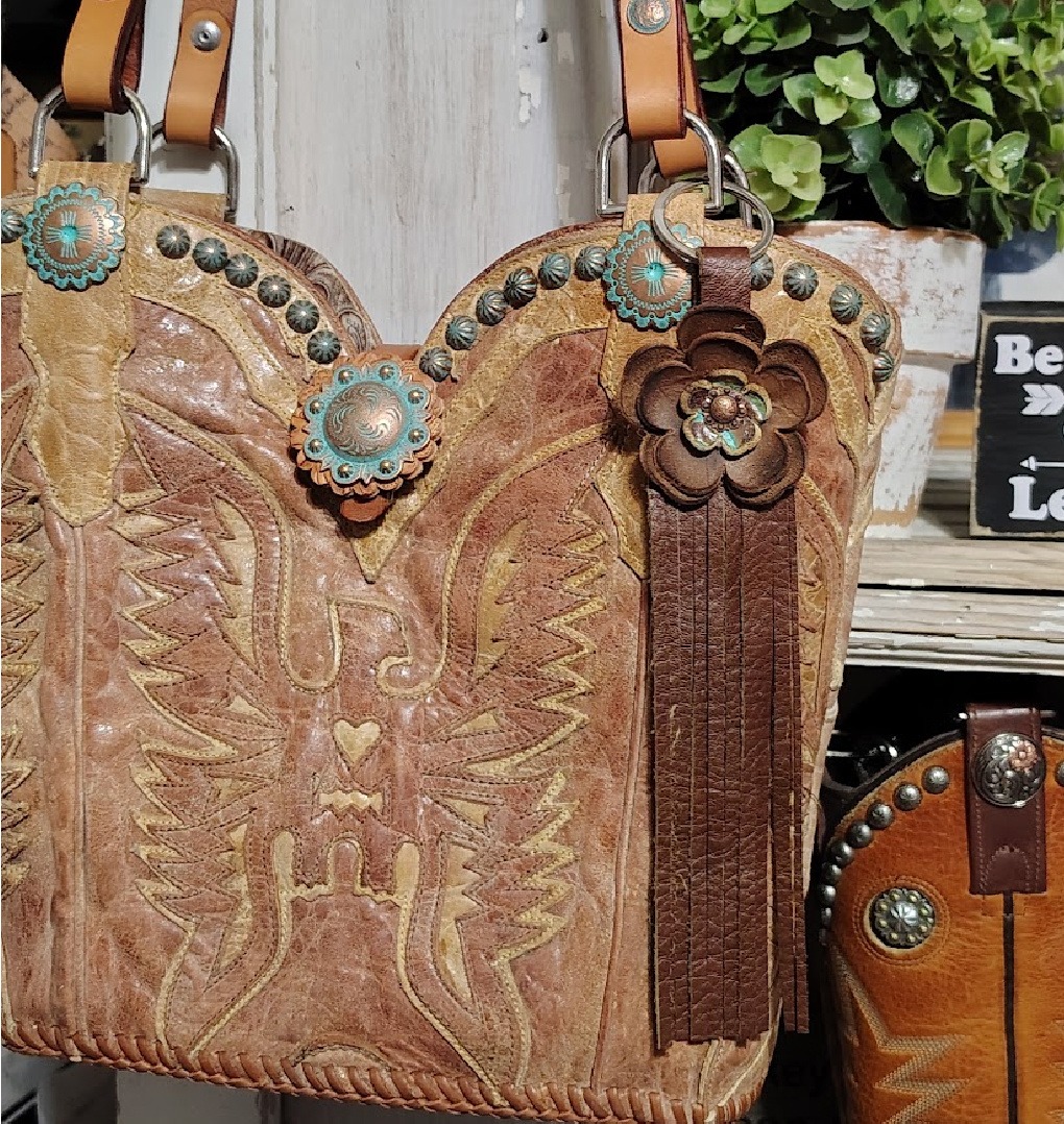 Leather flower accessory attached to a leather cowboy boot purse