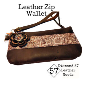 Brown zipper wallet with tooled leather accent, flower and wristlet strap