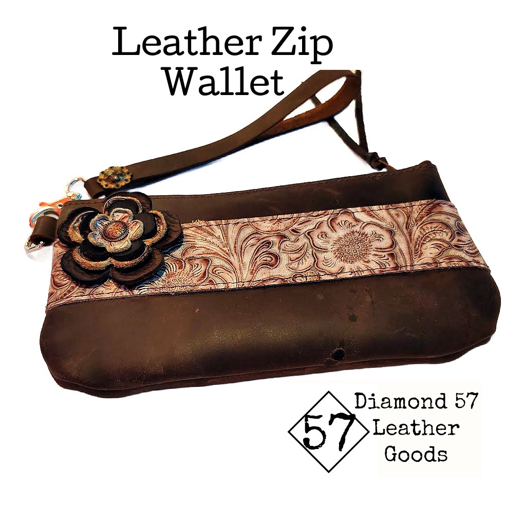 Brown zipper wallet with tooled leather accent, flower and wristlet strap
